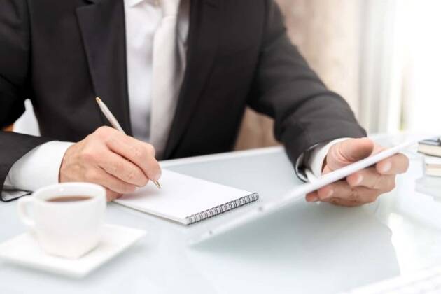 A person at a desk with pen and paper