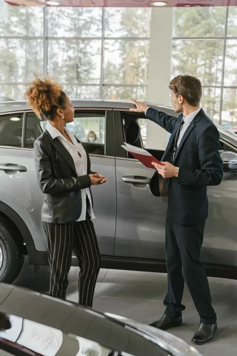 Man and woman by a car making the sale