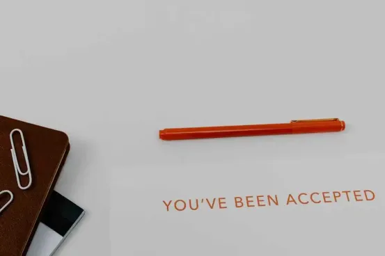 You've been accepted with a pen and corner with a notepad